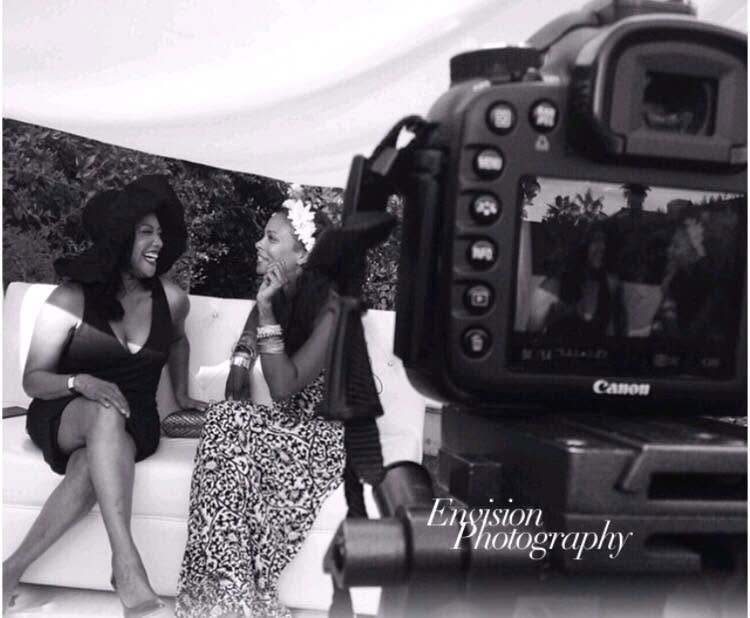 Black and white behind-the-scenes frame of an on-camera interview