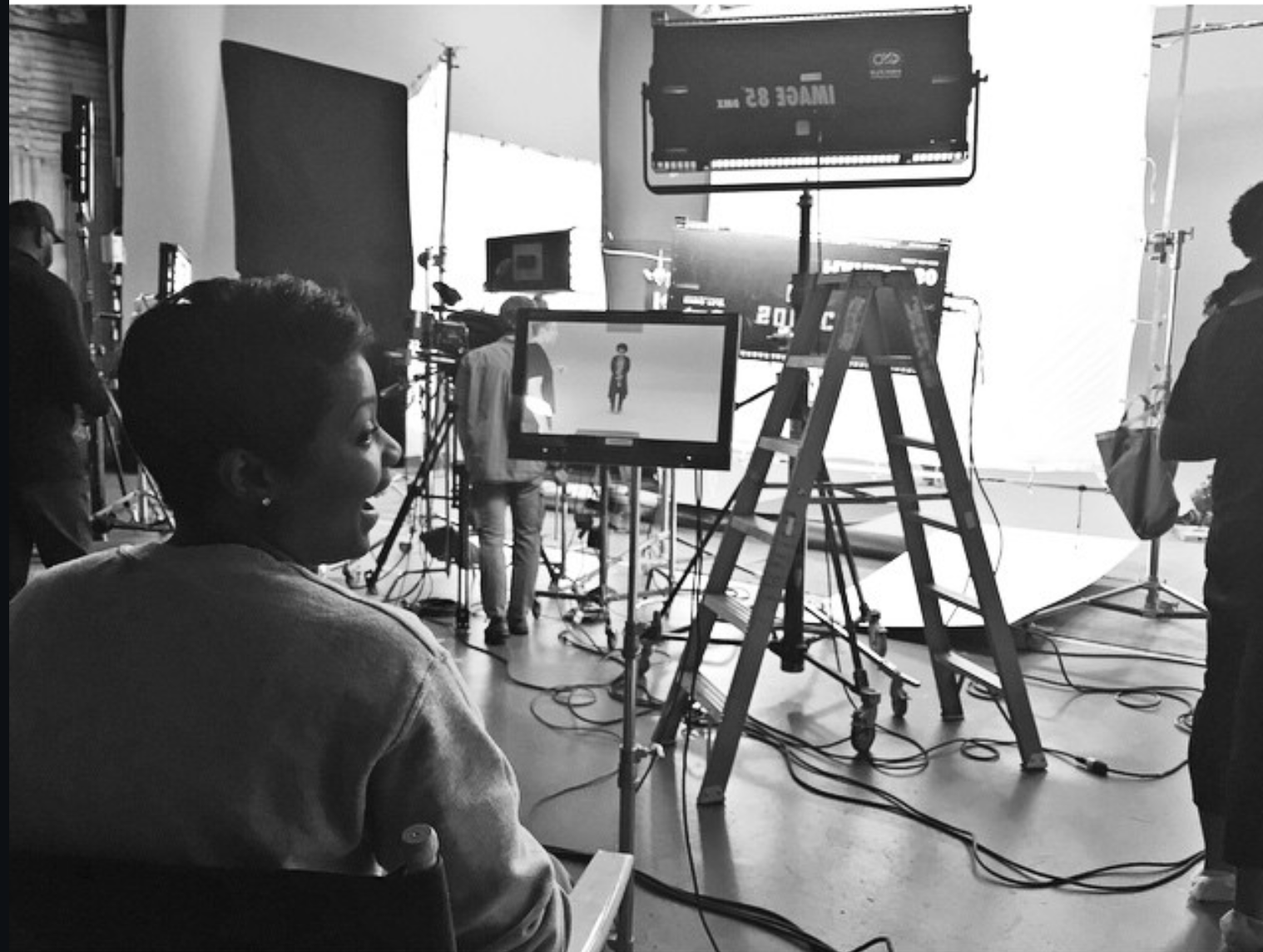 Black and white studio production setup with lighting and monitor